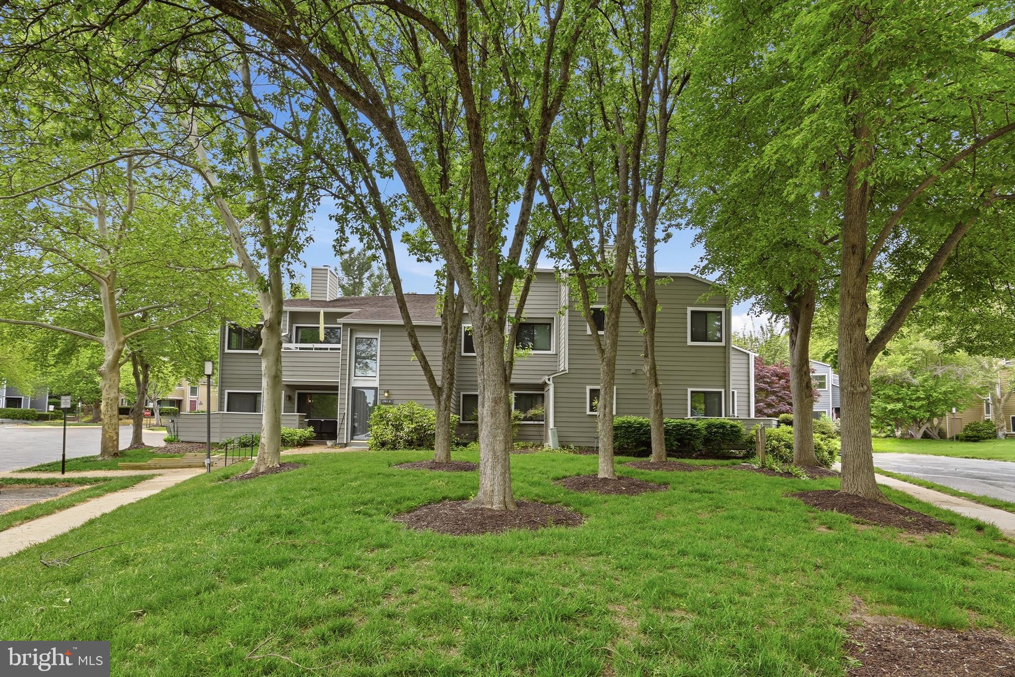 1907 Villaridge Drive Reston, VA 20191 - Photo 22 of 32 a view of a brick house with a big yard and large trees