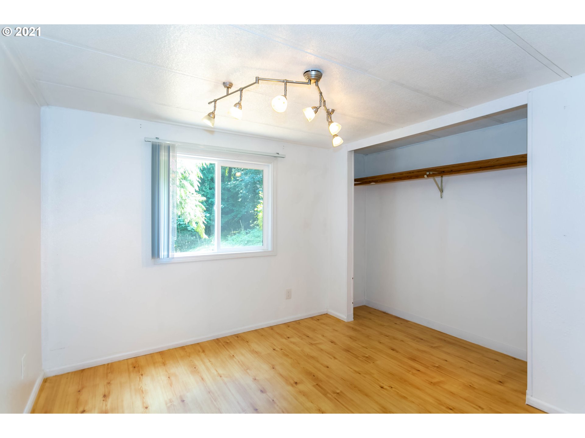 17580 Southeast Ten Eyck Road Sandy, OR 97055 - Photo 14 of 30 a view of an empty room with wooden floor and a window