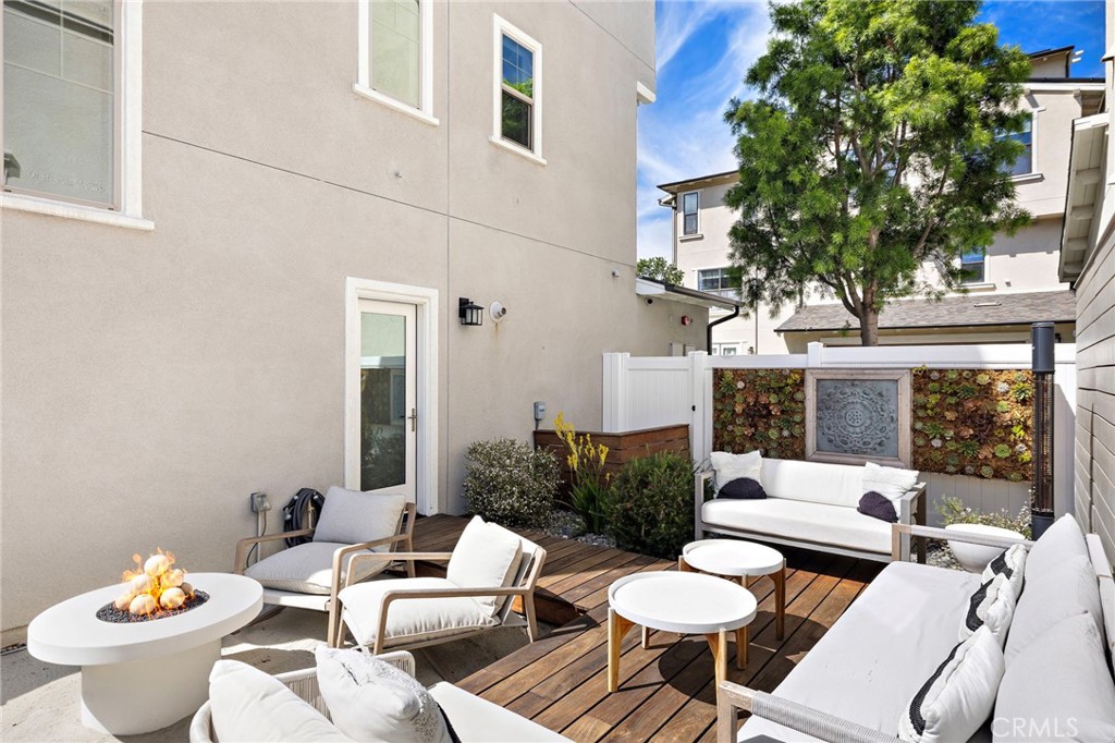 26 Yerra Street Rancho Mission Viejo, CA 92694 - Photo 16 of 75 a view of a patio with couches table and chairs and potted plants