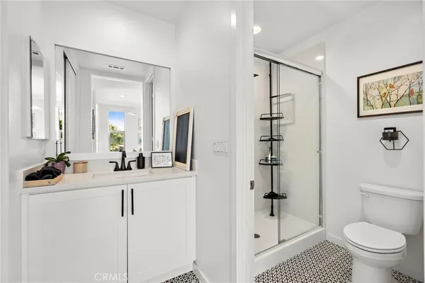 a large kitchen with lots of counter space a sink appliances and living room view