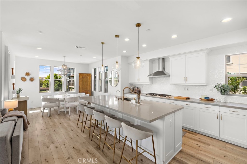 26 Yerra Street Rancho Mission Viejo, CA 92694 - Photo 34 of 75 a large kitchen with lots of counter space a sink appliances and living room view
