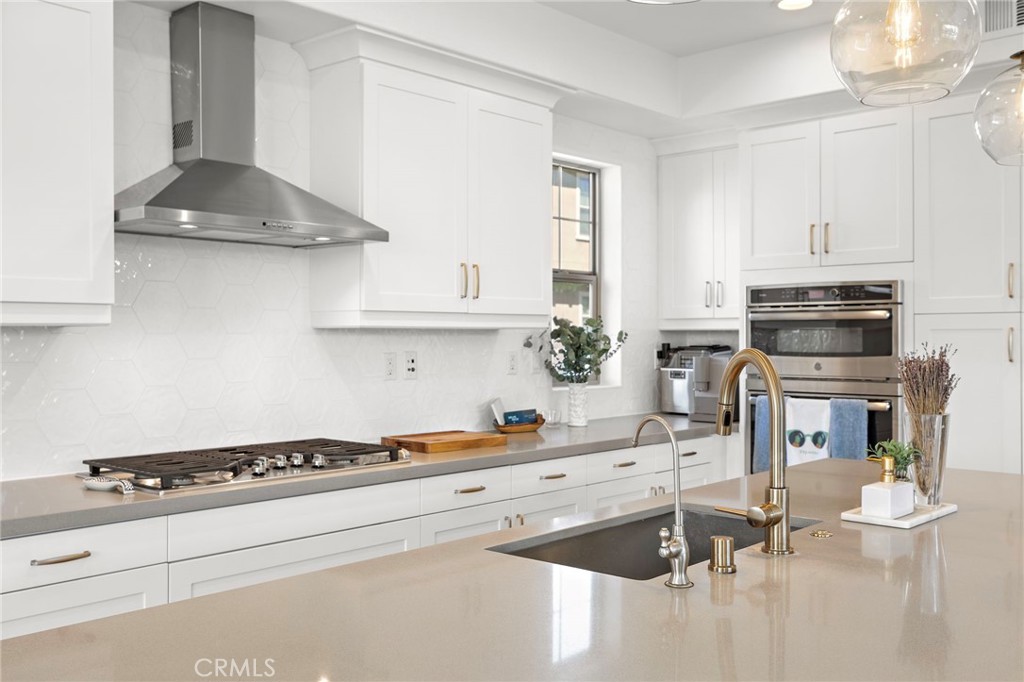 26 Yerra Street Rancho Mission Viejo, CA 92694 - Photo 36 of 75 a kitchen with stainless steel appliances a white stove top oven and white cabinets