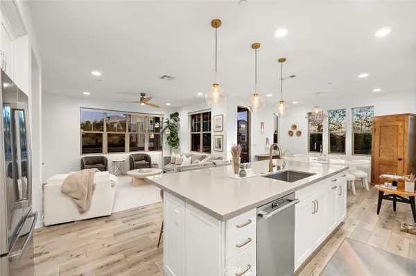 a kitchen with stainless steel appliances a sink cabinets and a window
