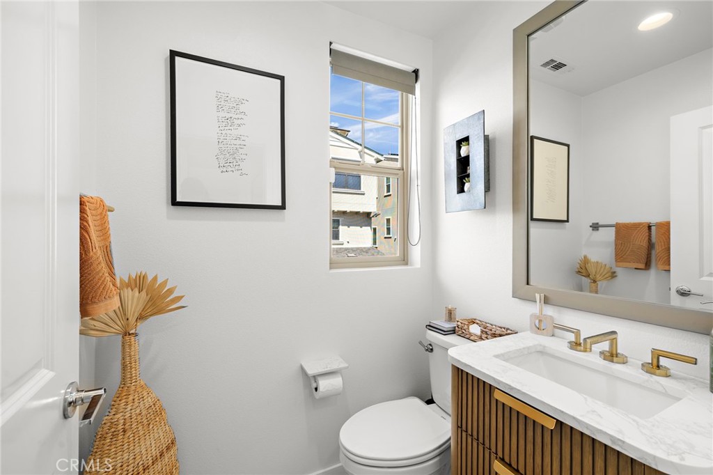26 Yerra Street Rancho Mission Viejo, CA 92694 - Photo 45 of 75 a bathroom with a sink a toilet and mirror