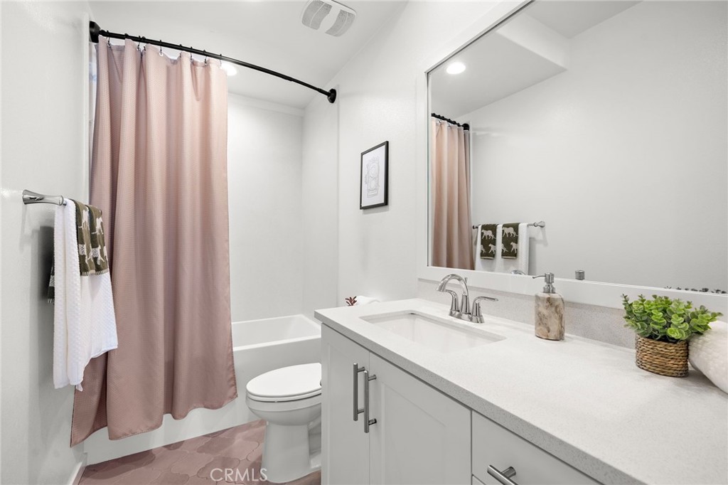 26 Yerra Street Rancho Mission Viejo, CA 92694 - Photo 52 of 75 a bathroom with a sink a toilet and shower curtain