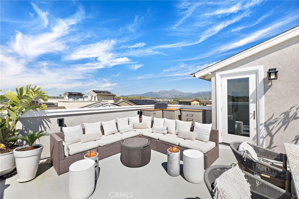 26 Yerra Street Rancho Mission Viejo, CA 92694 - Photo 56 of 75 a view of a patio with couches chairs potted plants and sky view