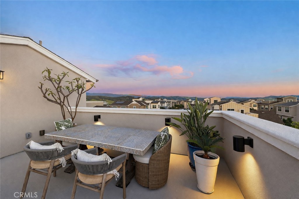 26 Yerra Street Rancho Mission Viejo, CA 92694 - Photo 60 of 75 Rooftop dining setting at dusk with glowing skies and hillside views.