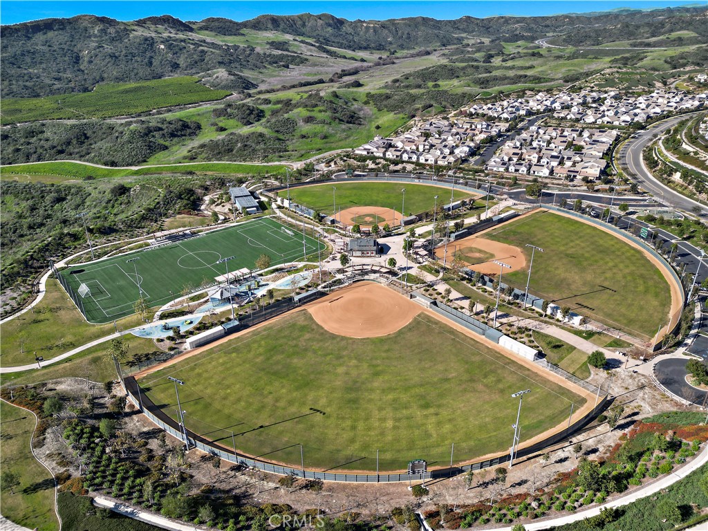 26 Yerra Street Rancho Mission Viejo, CA 92694 - Photo 64 of 75 an aerial view of a swimming pool with a mountain