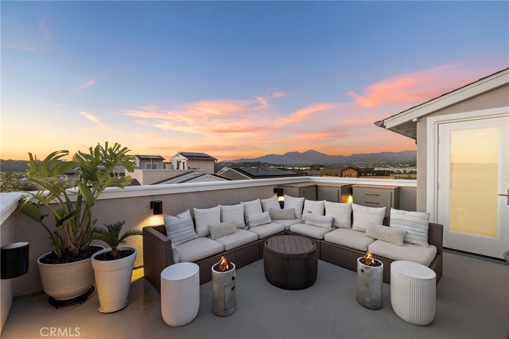 26 Yerra Street Rancho Mission Viejo, CA 92694 - Photo 74 of 75 Sky lounge glowing at dusk with open-air comfort and stylish seating.