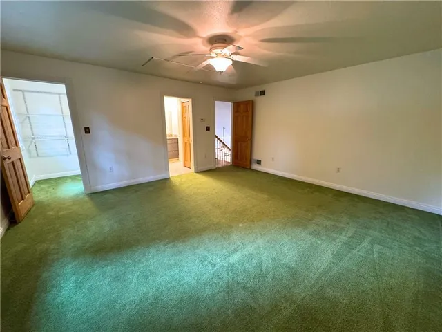 a view of an empty room with window and fireplace