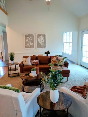 a living room with furniture potted plant and a window