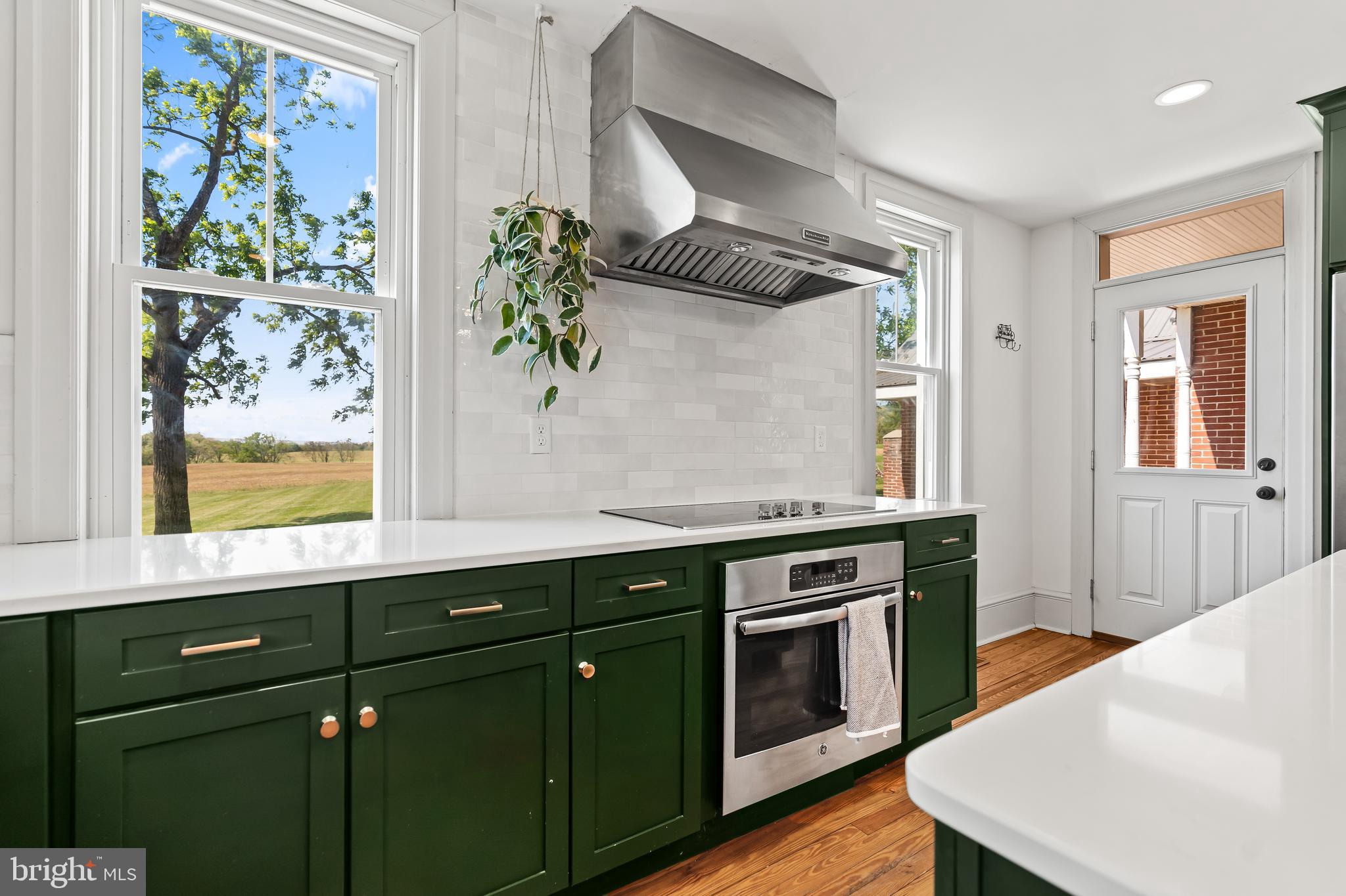 14005 Dry Run Road Clear Spring, MD 21722 - Photo 19 of 44 a kitchen with stainless steel appliances granite countertop a stove a sink and a wooden floor