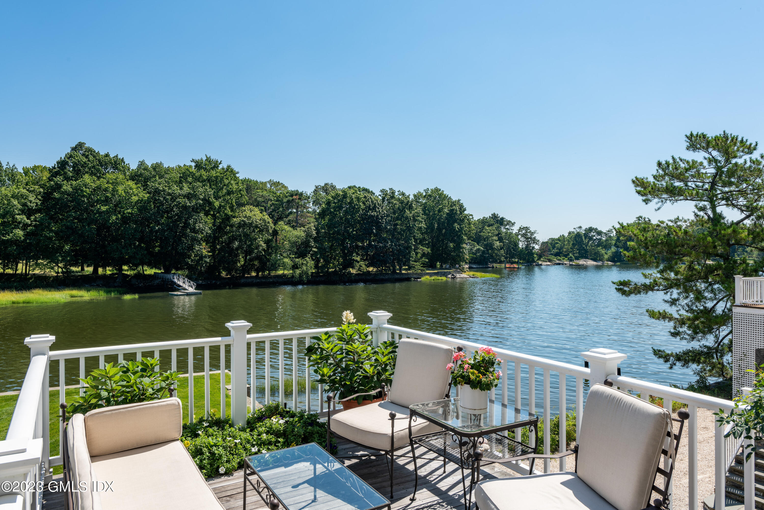 633 Steamboat Road, Unit 2 Greenwich, CT 06830 - Photo 8 of 27 a view of a chair and tables on the lake