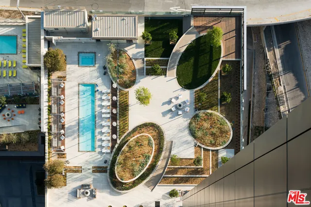 a view of a building with a bench and potted plants