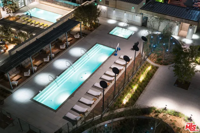 a view of a swimming pool with outdoor seating