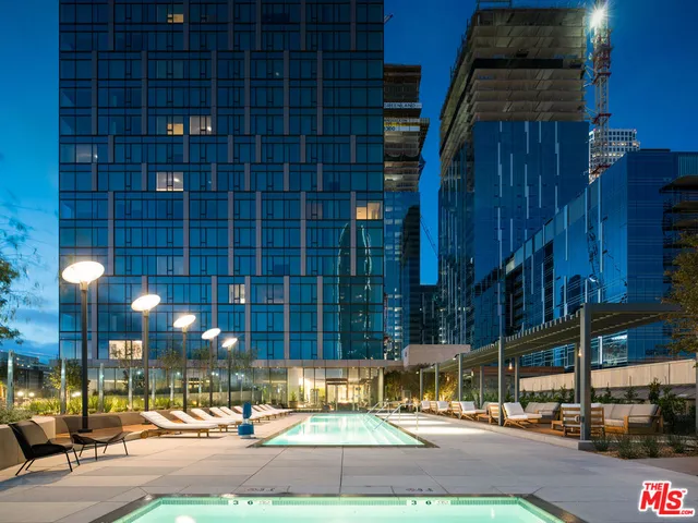 a living room with furniture and large windows