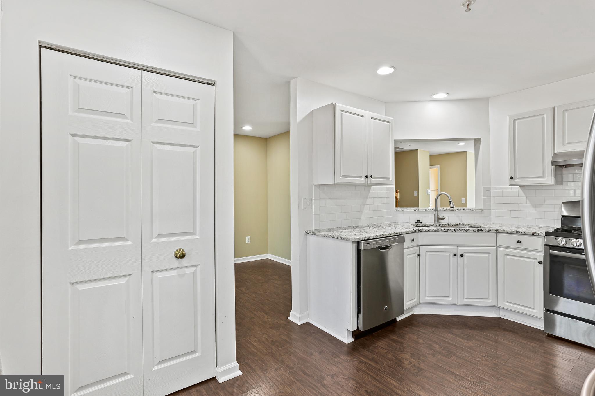 662 Howards Loop Annapolis, MD 21401 - Photo 12 of 29 a spacious bathroom with a granite countertop sink and a mirror