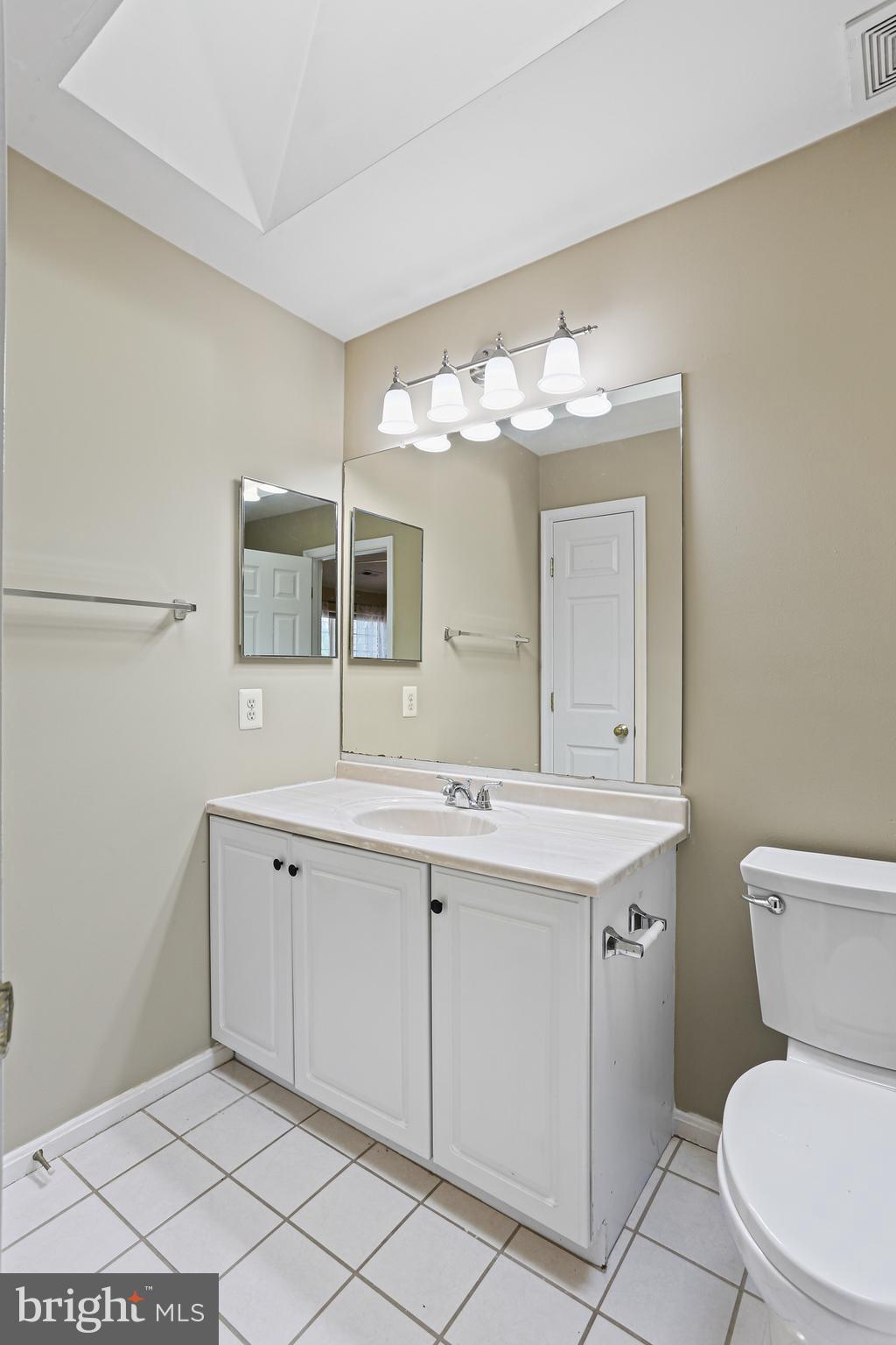 662 Howards Loop Annapolis, MD 21401 - Photo 16 of 29 a bathroom with a toilet sink and mirror