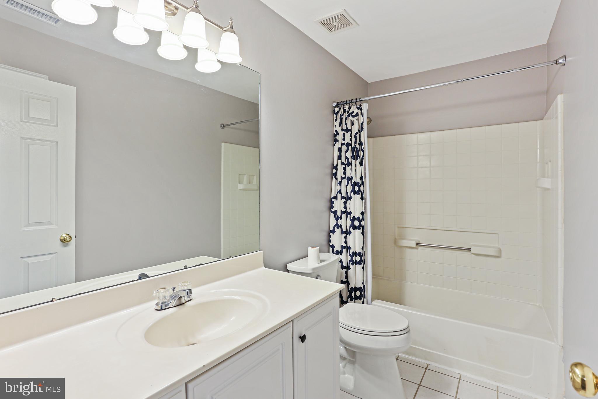 662 Howards Loop Annapolis, MD 21401 - Photo 23 of 29 a bathroom with a sink a toilet a mirror and shower