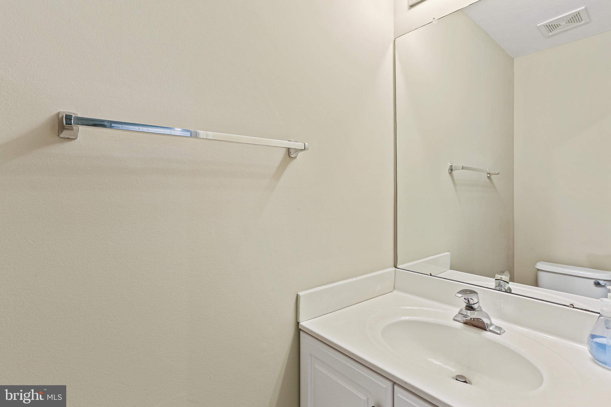662 Howards Loop Annapolis, MD 21401 - Photo 5 of 29 a bathroom with a sink and a mirror