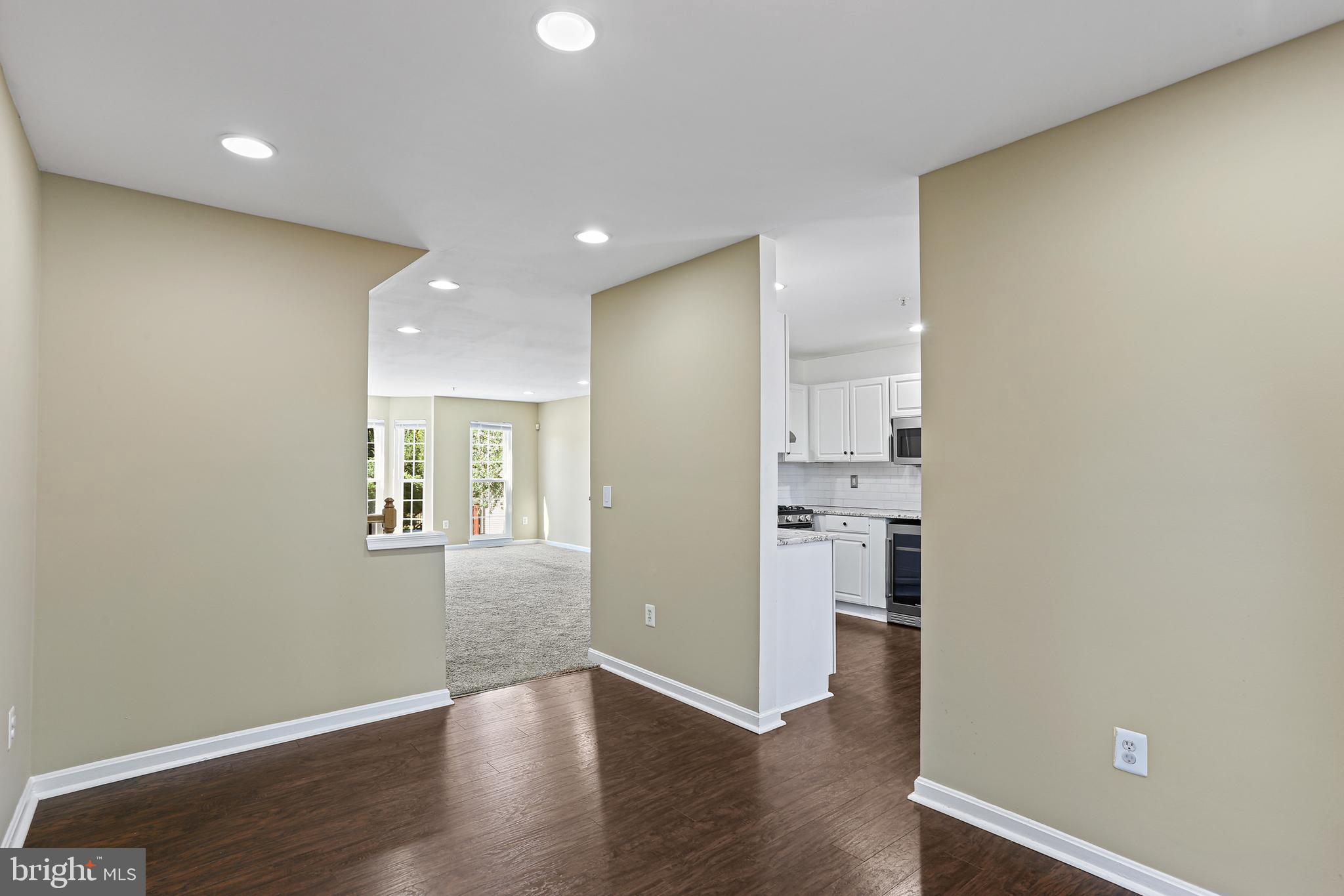 662 Howards Loop Annapolis, MD 21401 - Photo 10 of 29 wooden floor in an empty room with a kitchen