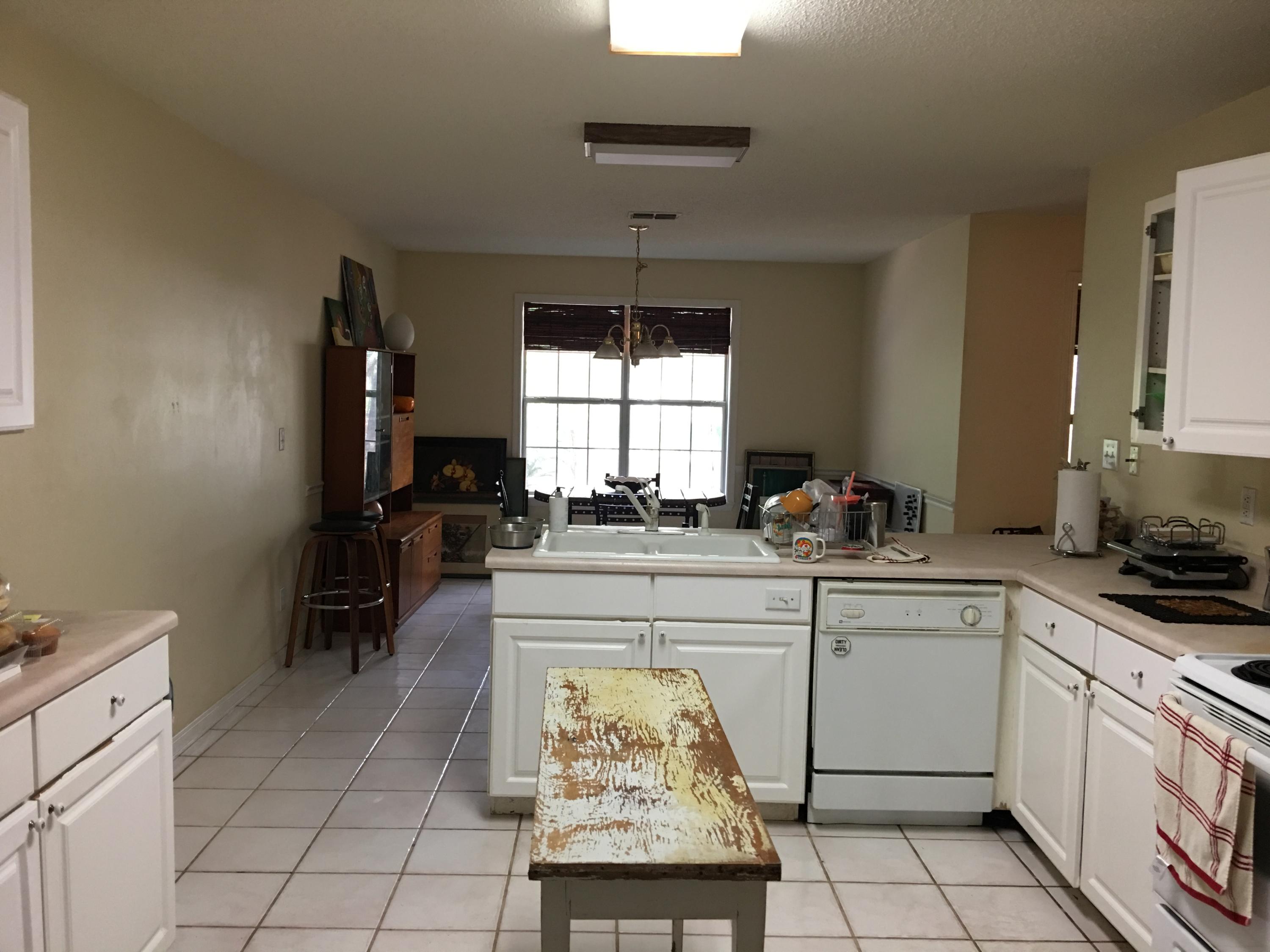 274 North Bishop Road Santa Rosa Beach, FL 32459 - Photo 2 of 17 a kitchen with a stove a sink and a refrigerator