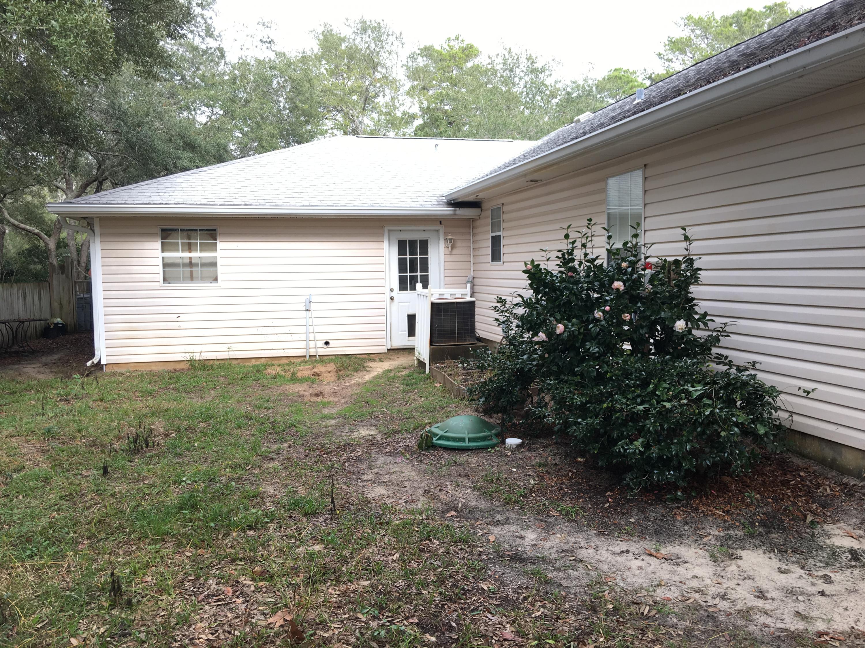 274 North Bishop Road Santa Rosa Beach, FL 32459 - Photo 16 of 17 a view of a house with a yard and plants