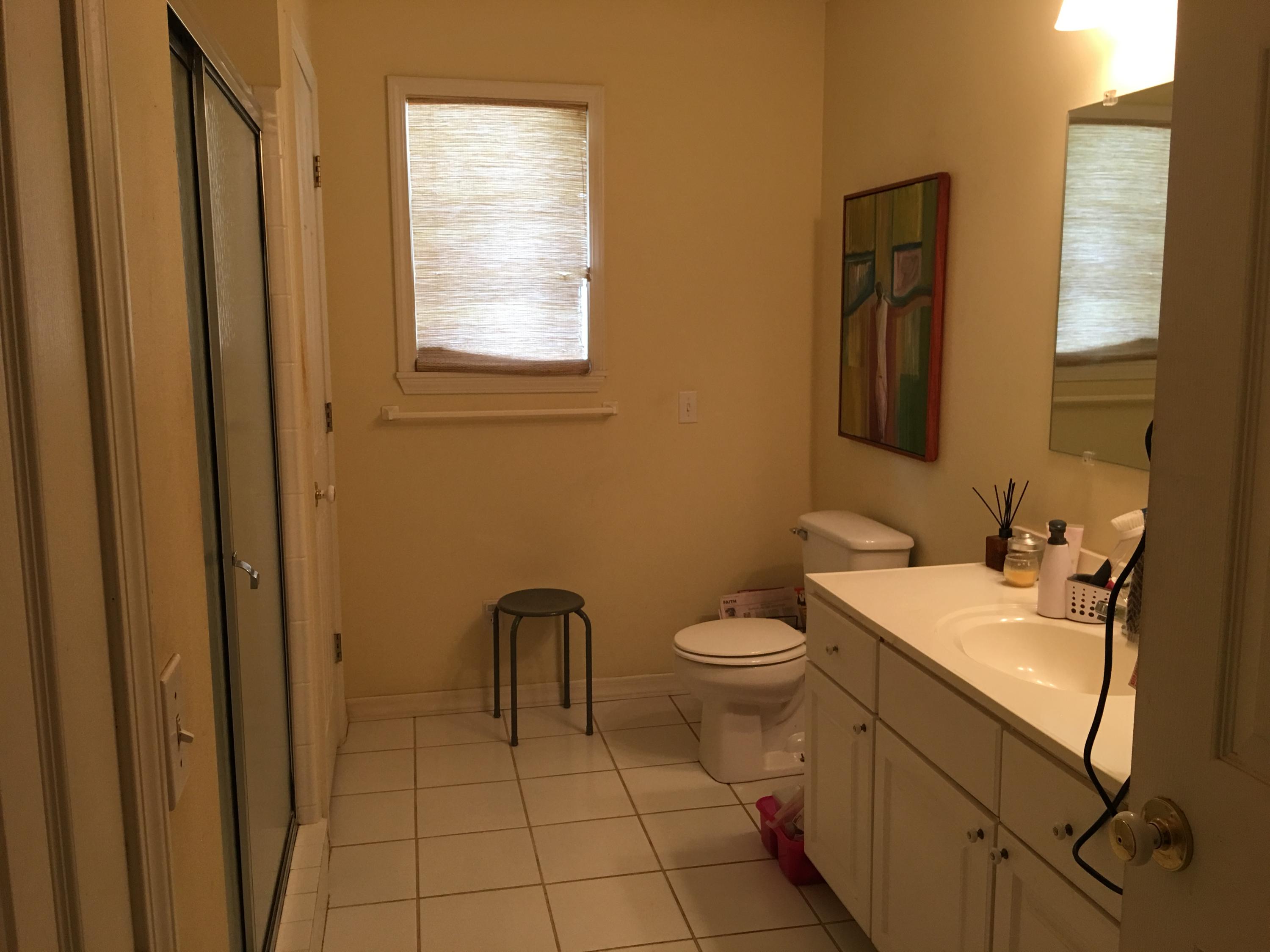 274 North Bishop Road Santa Rosa Beach, FL 32459 - Photo 4 of 17 a bathroom with a toilet sink vanity and mirror