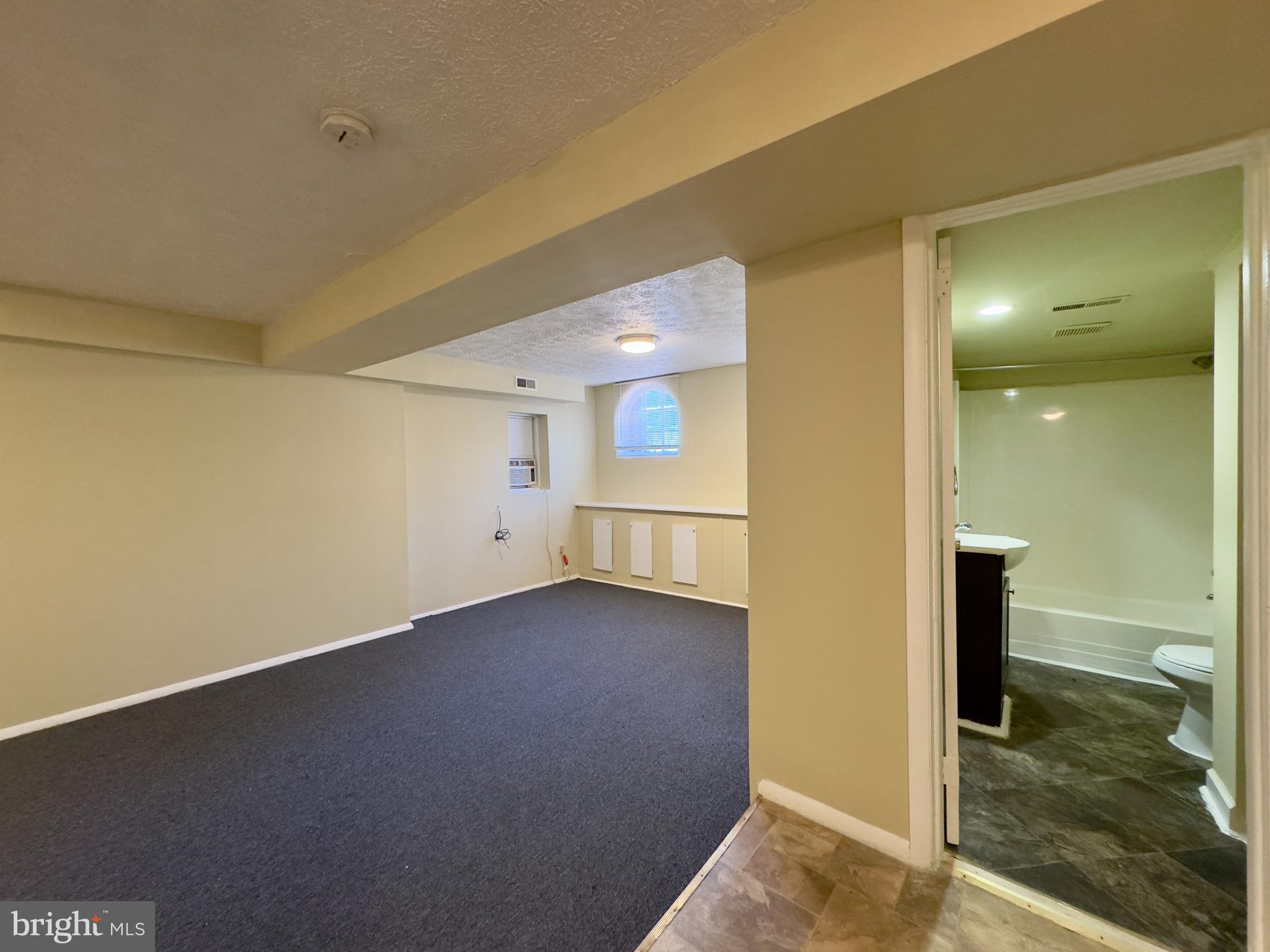 1503 Eutaw Place, Unit B1 Baltimore, MD 21217 - Photo 3 of 7 a view of a room has a big room with wooden floor
