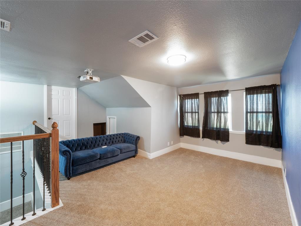 7321 North State Highway Blue Ridge, TX 75424 - Photo 19 of 30 Bonus room featuring a textured ceiling, light colored carpet, and lofted ceiling