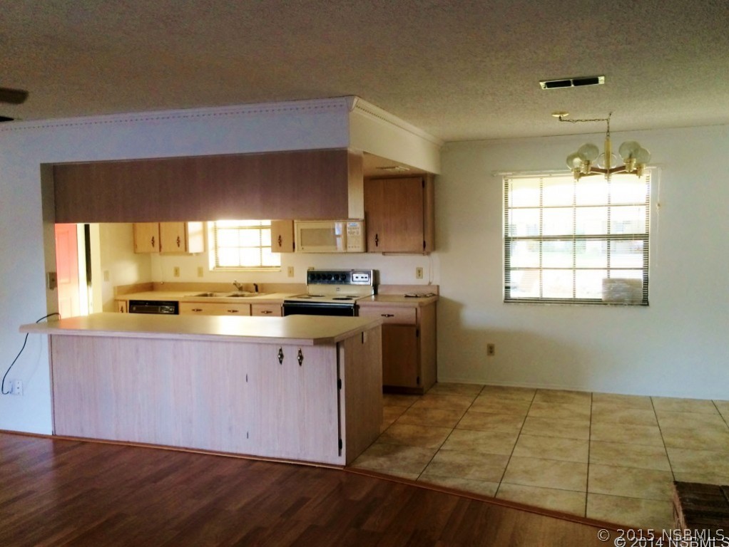 509 Cardinal Drive Edgewater, FL 32141 - Photo 2 of 10 a kitchen with a sink cabinets and window