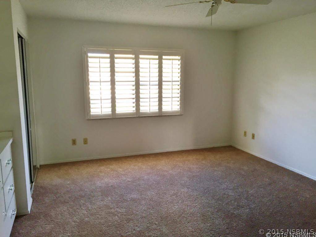 509 Cardinal Drive Edgewater, FL 32141 - Photo 6 of 10 an empty room with a window