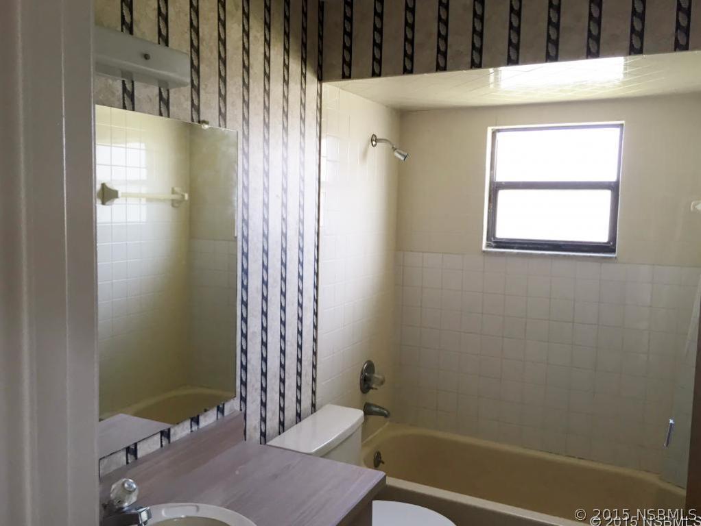 509 Cardinal Drive Edgewater, FL 32141 - Photo 8 of 10 a bathroom with a sink and a shower