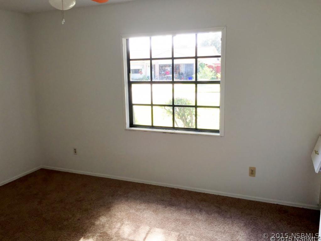 509 Cardinal Drive Edgewater, FL 32141 - Photo 10 of 10 an empty room with a window