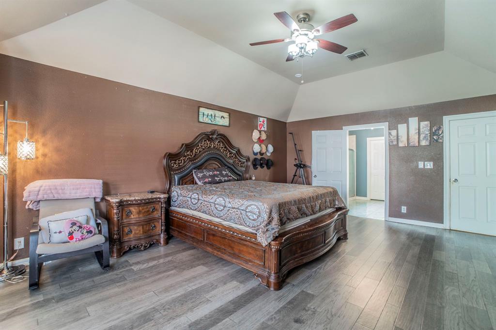 3934 Harlingen Street Dallas, TX 75212 - Photo 13 of 26 a bedroom with a bed and a chandelier