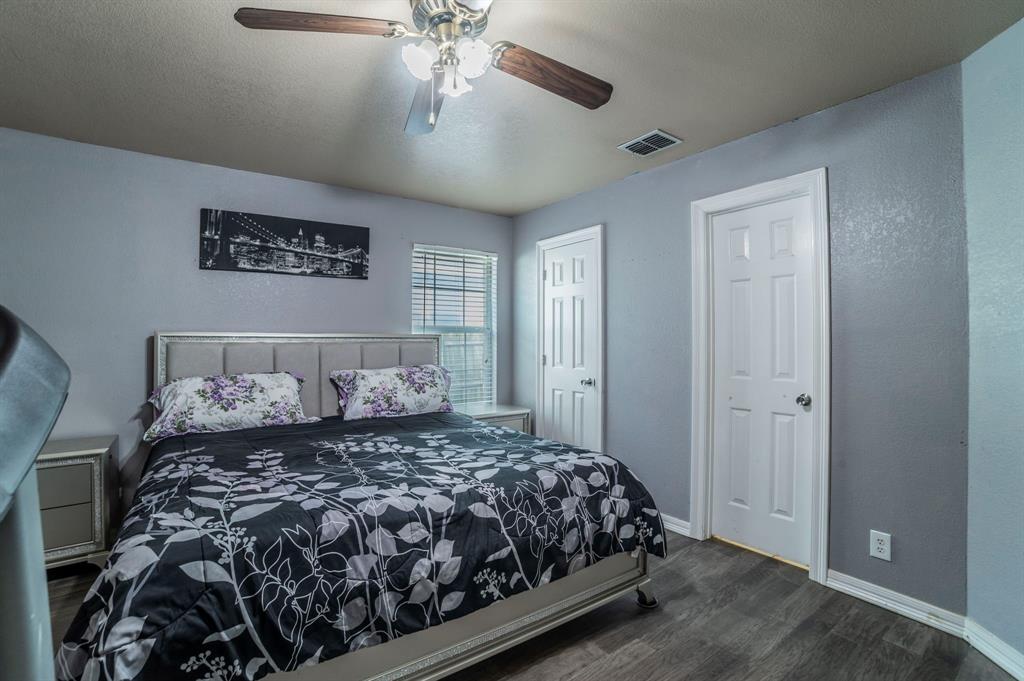 3934 Harlingen Street Dallas, TX 75212 - Photo 16 of 26 a bedroom with a large bed and a chandelier