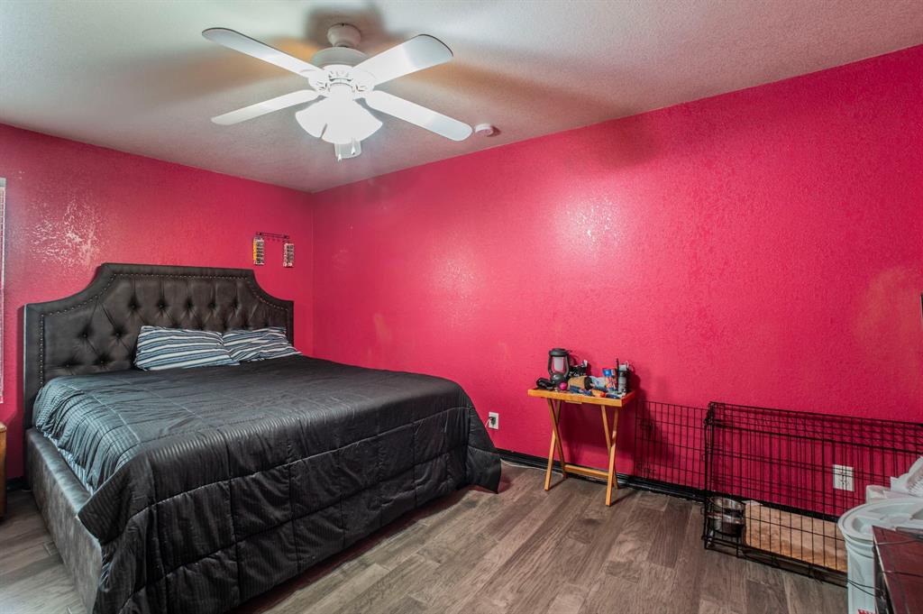 3934 Harlingen Street Dallas, TX 75212 - Photo 19 of 26 a bedroom with a bed and a chandelier
