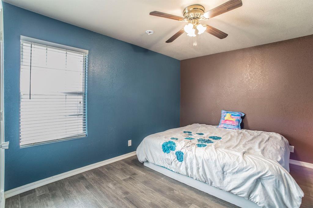 3934 Harlingen Street Dallas, TX 75212 - Photo 21 of 26 a bedroom with a bed and a chandelier