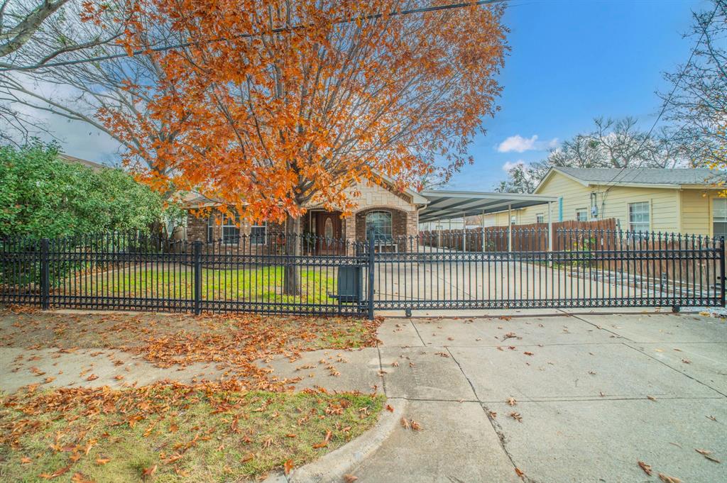 3934 Harlingen Street Dallas, TX 75212 - Photo 3 of 26 a view of a house with a floor to ceiling windows and a yard