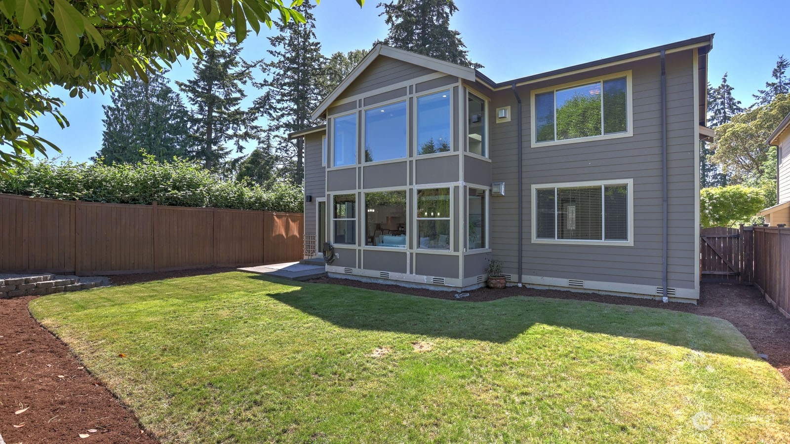 1152 Queen Avenue Northeast Renton, WA 98056 - Photo 38 of 40 a view of house with backyard outdoor seating and entertaining space
