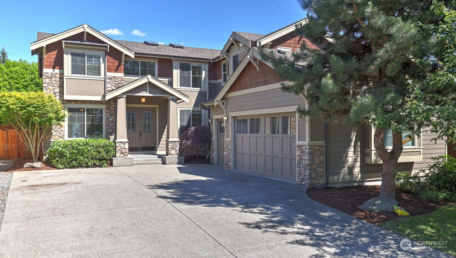 1152 Queen Avenue Northeast Renton, WA 98056 - Photo 4 of 40 a front view of a house with a yard and trees