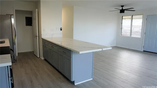 an empty room with wooden floor and a window