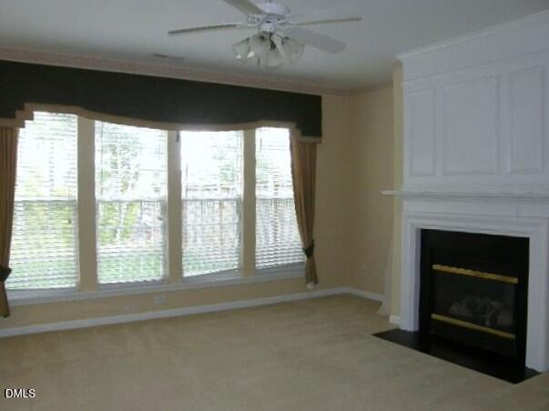 102 Willingham Road Morrisville, NC 27560 - Photo 5 of 19 a living room with a fireplace and a large window