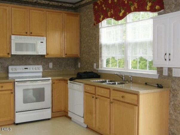 102 Willingham Road Morrisville, NC 27560 - Photo 8 of 19 a kitchen with a sink stove and cabinets