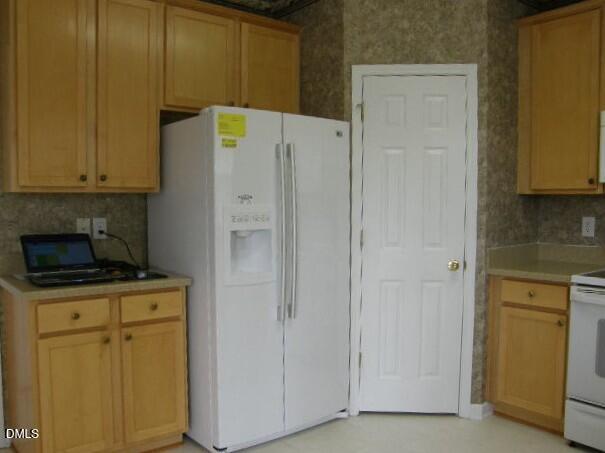 102 Willingham Road Morrisville, NC 27560 - Photo 9 of 19 a kitchen with a refrigerator stove and cabinets
