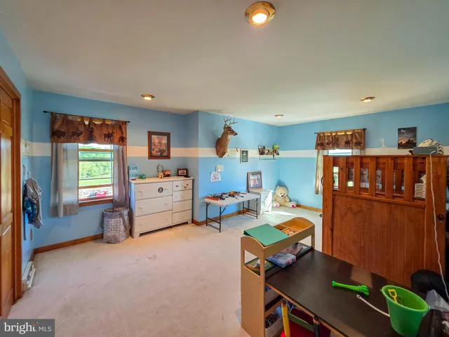a view of a hallway view with wooden floor and furniture
