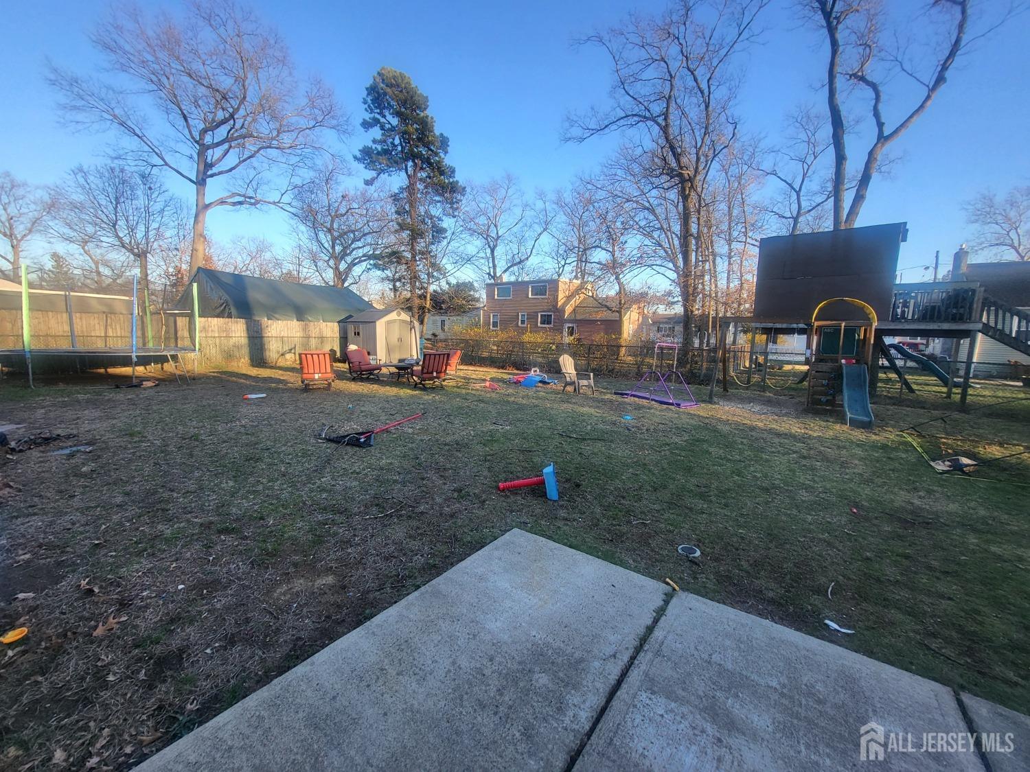 45 James Avenue Old Bridge, NJ 08857 - Photo 2 of 2 a backyard of a house with table and chairs