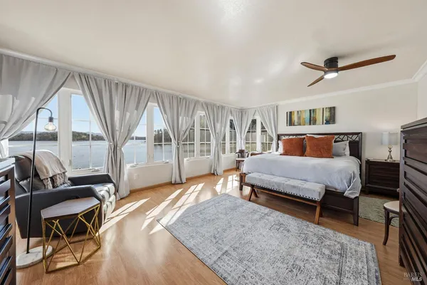 a bedroom with a large bed and a large window