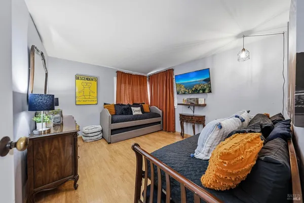 a view of a balcony with wooden floor and outdoor seating