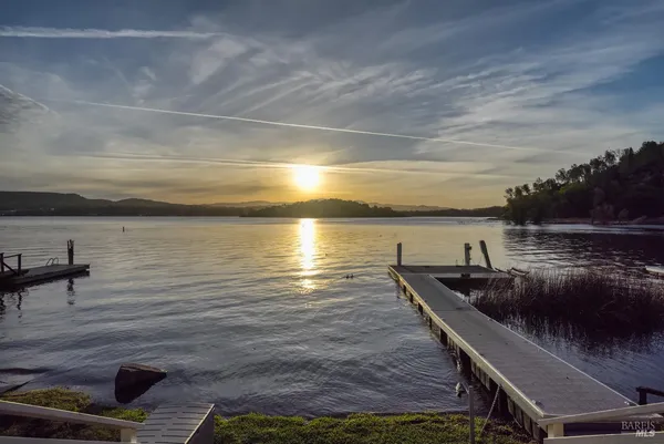 a view of a house with a yard and furniture